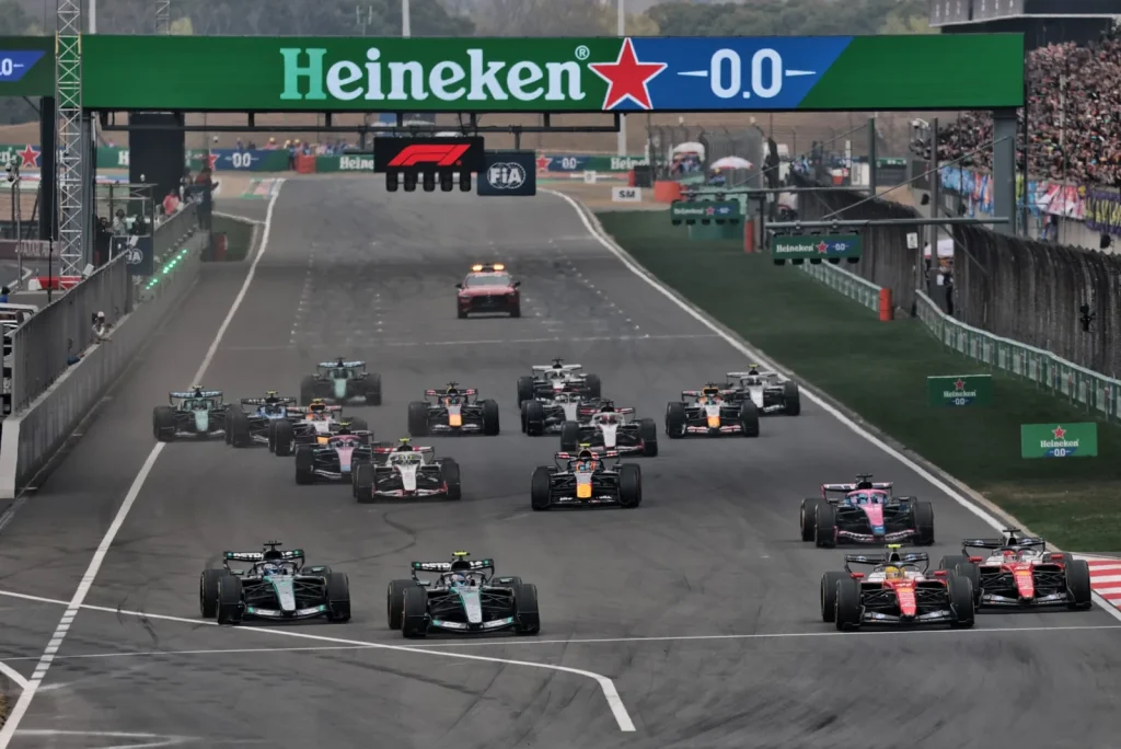 Lewis Hamilton (GBR) Scuderia Ferrari SF-26 passes Andrea Kimi Antonelli (ITA) Mercedes AMG Formula One Team W17 at the start of the race.
