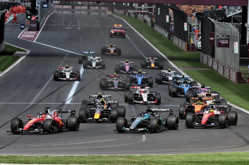 George Russell (GBR) Mercedes AMG Formula One Team W17 is passed by Charles Leclerc (MON) Scuderia Ferrari SF-26 at the start of the race.