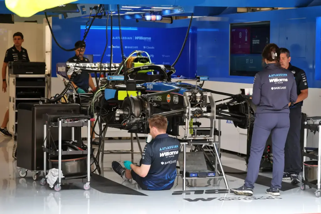 Williams F1 Team FW48 being prepared by mechanics in the pit garage.