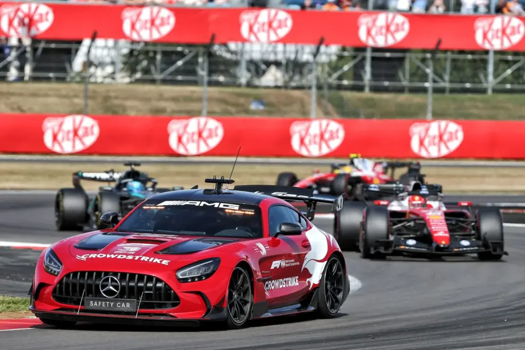 Charles Leclerc (MON) Scuderia Ferrari SF-26 leads behind the Mercedes FIA Safety Car.