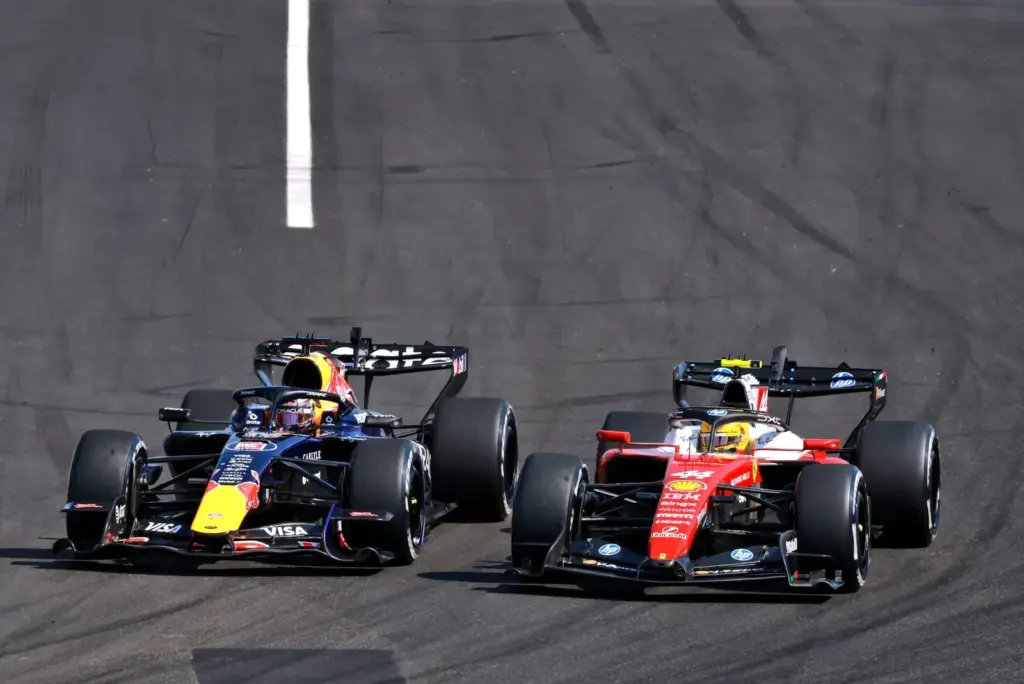 Max Verstappen (NLD) Red Bull Racing RB22 and Lewis Hamilton (GBR) Scuderia Ferrari SF-26 battle for position.
