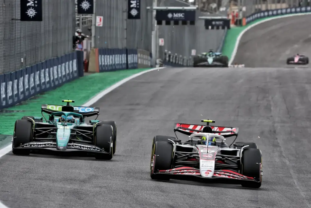 Fernando Alonso (ESP) Aston Martin F1 Team AMR25 and Oliver Bearman (GBR) Haas VF-25 battle for position.