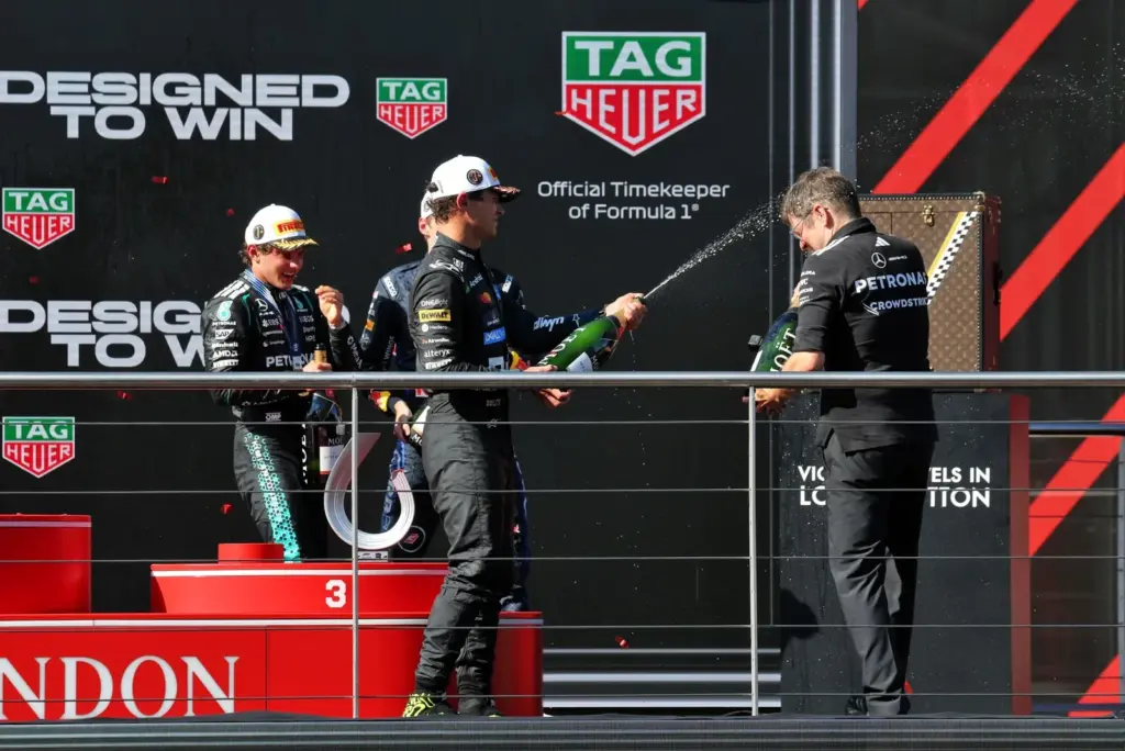 (L to R): Race winner Andrea Kimi Antonelli (ITA) Mercedes AMG Formula One Team celebrates on the podium with Max Verstappen (NLD) Red Bull Racing; Lando Norris (GBR) McLaren F1 Team; and David Lamb (GBR) Mercedes AMG High Performance Powertrains Performance Engineer.